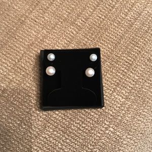 Double pearl pierced earrings.